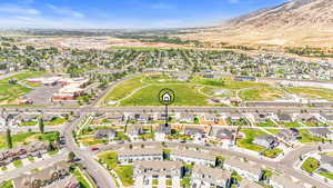 Aerial overview of property's location with a mountain backdrop and nearby suburban area