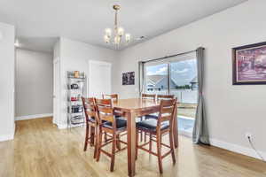 Dining room featuring a chandelier and light wood-style floors