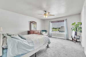 Primary Bedroom with carpet flooring and ceiling fan