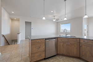 Kitchen featuring light tile patterned flooring, stainless steel dishwasher, pendant lighting, recessed lighting, and light stone counters
