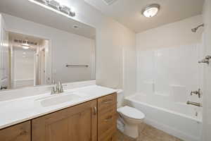 Bathroom with vanity, tile patterned flooring, and shower / bath combination
