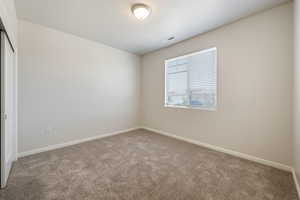 Unfurnished room with carpet flooring and baseboards
