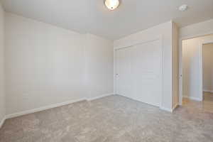 Unfurnished bedroom with carpet floors and a closet