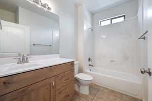 Bathroom featuring vanity, shower / tub combination, and tile patterned floors