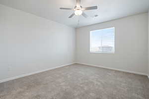 Spare room with carpet floors and ceiling fan