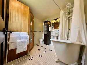 Bathroom featuring tile patterned flooring and toilet