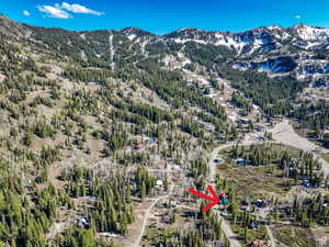 Aerial view of property and surrounding area featuring mountains