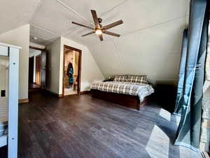 Bedroom featuring lofted ceiling, wood finished floors, a ceiling fan, and a textured ceiling