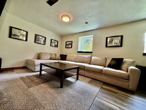 Living area featuring a textured ceiling and wood finished floors