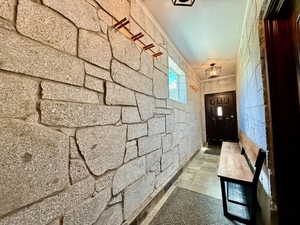 Corridor featuring stone tile floors