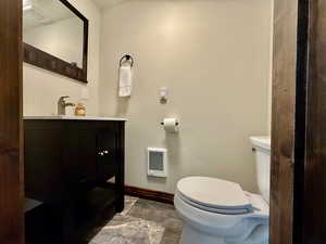 Half bath featuring vanity and heating unit
