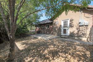 Rear view of property featuring a patio and stucco siding