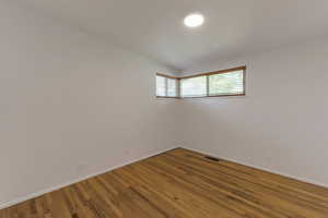 Empty room with baseboards and wood finished floors