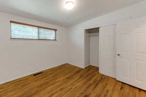 Unfurnished bedroom with light wood finished floors and a closet