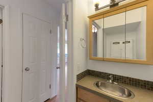 Bathroom with vanity and backsplash