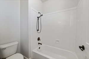 Full bathroom featuring toilet and shower / washtub combination