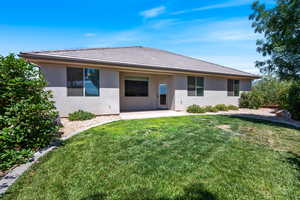 Rear view of house featuring a patio, stucco siding, a yard, and a tiled roof