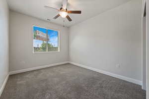 Unfurnished room featuring carpet floors and a ceiling fan