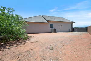 Back of property featuring stucco siding and a tile roof