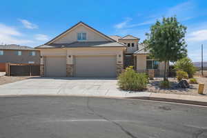 View of front of home featuring stucco siding, an attached garage, concrete driveway, a tiled roof, and stone siding