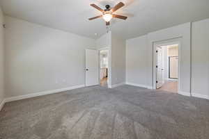 Unfurnished bedroom with carpet flooring, vaulted ceiling, and a ceiling fan