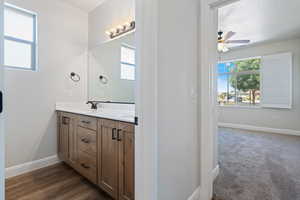 Full bath with double vanity and ceiling fan