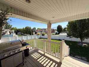 Wooden deck featuring area for grilling, a residential view, and a fenced backyard