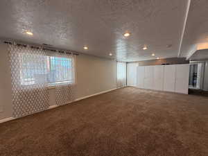 Unfurnished room featuring carpet floors, a textured ceiling, and recessed lighting