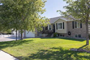 View of front of home with brick siding and concrete driveway