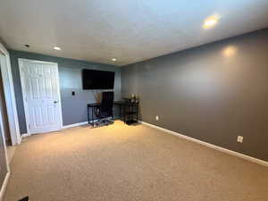 Carpeted home office featuring baseboards and recessed lighting