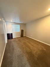 Spare room featuring baseboards and carpet floors