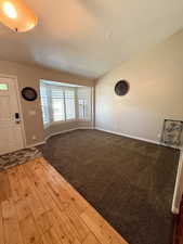 Entryway featuring wood finished floors and lofted ceiling