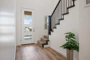 Entryway featuring wood finished floors and stairs