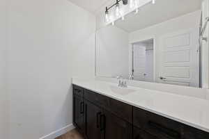 Bathroom featuring vanity and wood finished floors