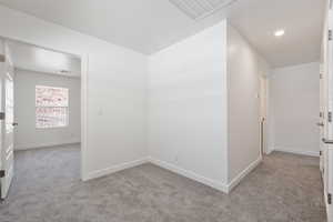 Empty room with carpet floors and recessed lighting