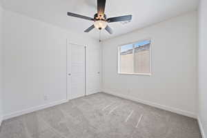 Unfurnished bedroom with carpet floors, a closet, and ceiling fan