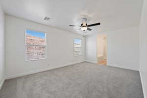 Carpeted spare room with baseboards and a ceiling fan