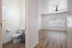 Bathroom with wood finished floors and ceiling fan