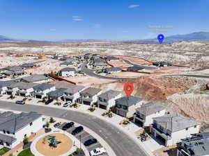 Aerial perspective of suburban area featuring a mountainous background