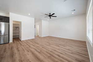 Unfurnished living room with light wood-style floors, recessed lighting, and ceiling fan