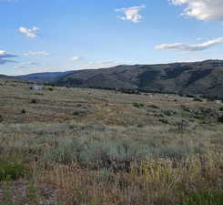 View of mountain backdrop with rural landscape