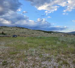 View of mountain backdrop featuring rural landscape