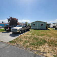 View of side of property featuring a yard