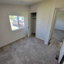 Unfurnished bedroom with carpet flooring
