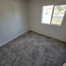 Carpeted empty room with baseboards