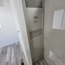 Detailed view of a heating unit and wood finished floors