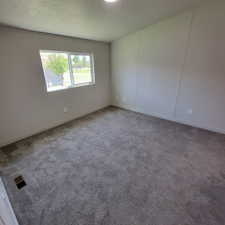 Spare room with baseboards and carpet floors
