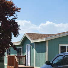 View of side of property featuring a shingled roof