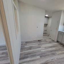 Unfurnished dining area with light wood-style flooring and recessed lighting