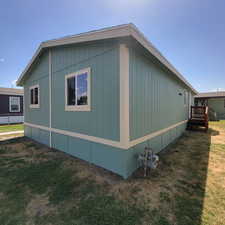 View of side of property featuring a lawn